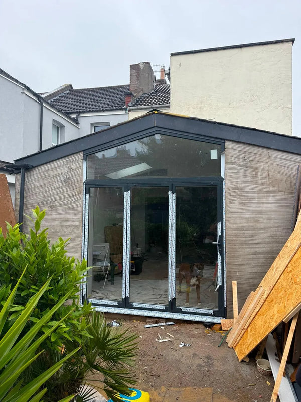 Interior view of aluminium sliding doors and apex gable glazing in a garden-room extension, Bristol
