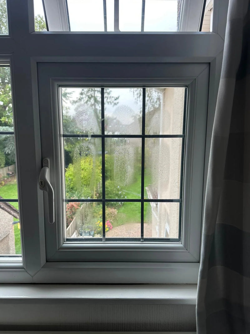 Condensation bubbles and moisture between panes of Georgian window in Bristol