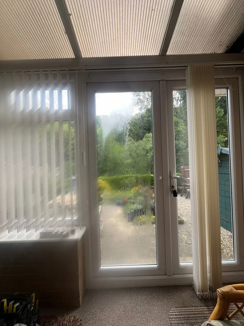 Conservatory door with misted double glazed glass before replacement in Bristol