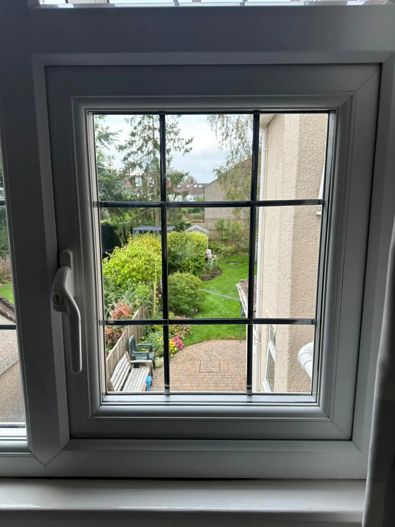 Georgian casement window repaired with clear glass and garden view in Bristol