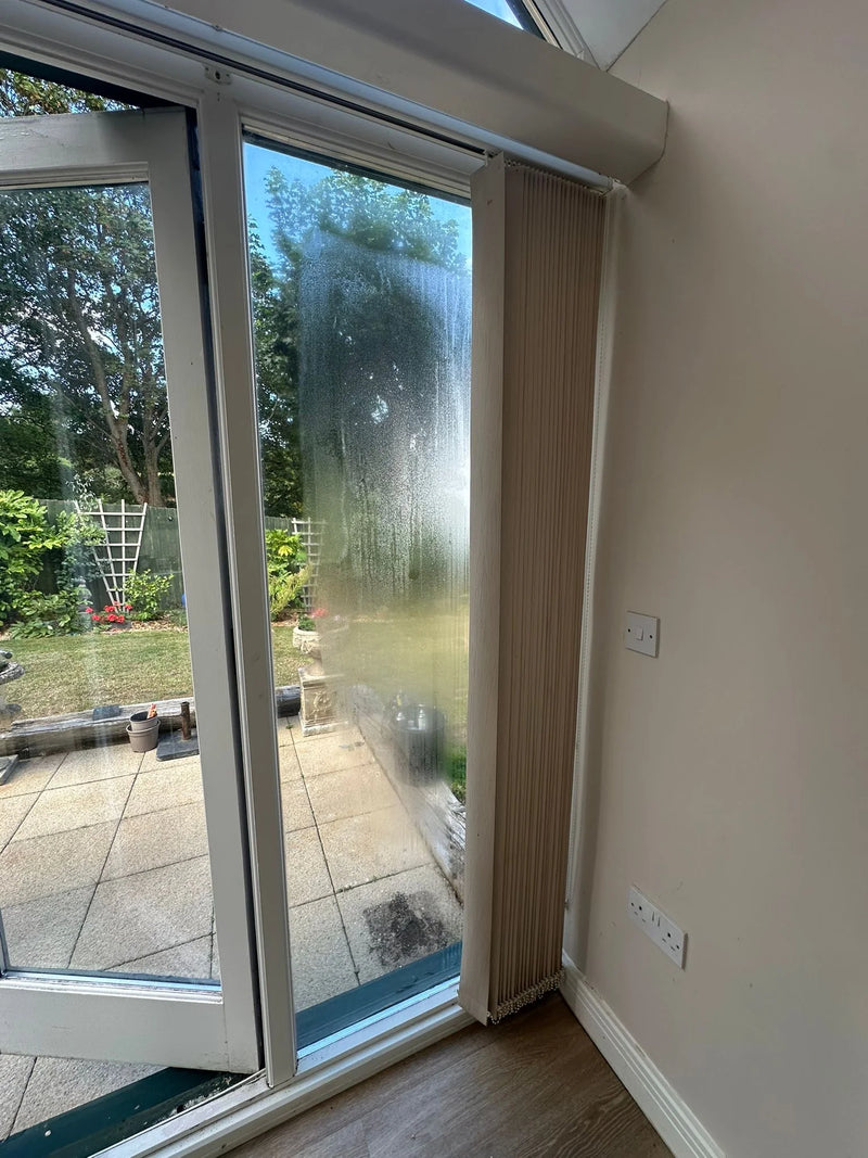 Misted patio sliding door glass with failed seal before repair in Bristol