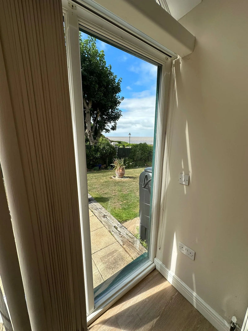 New clear patio door glass with unobstructed coastal garden view after replacement near Bristol