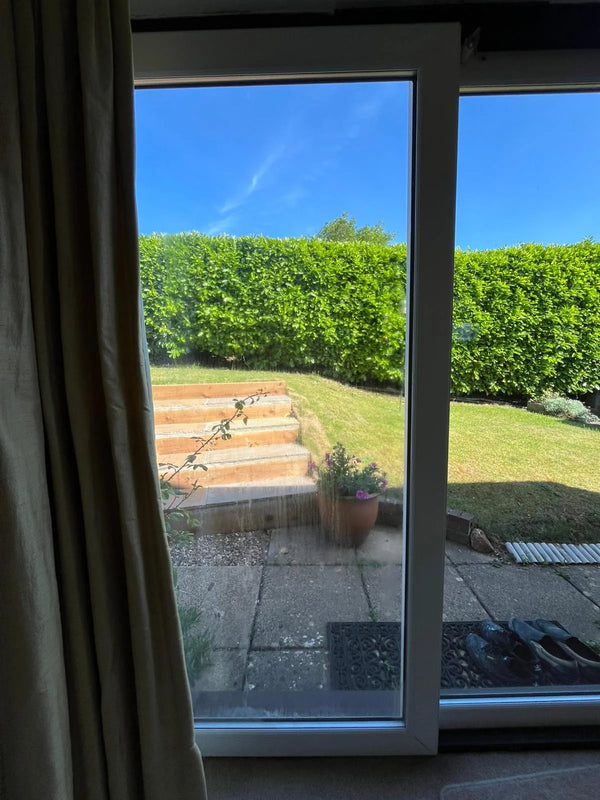 Replacement patio door glass with new clear sealed unit overlooking garden near Bristol