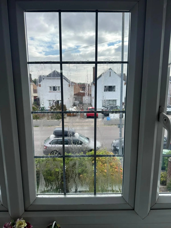 Street-facing leaded window with failed seal allowing noise penetration in Bristol