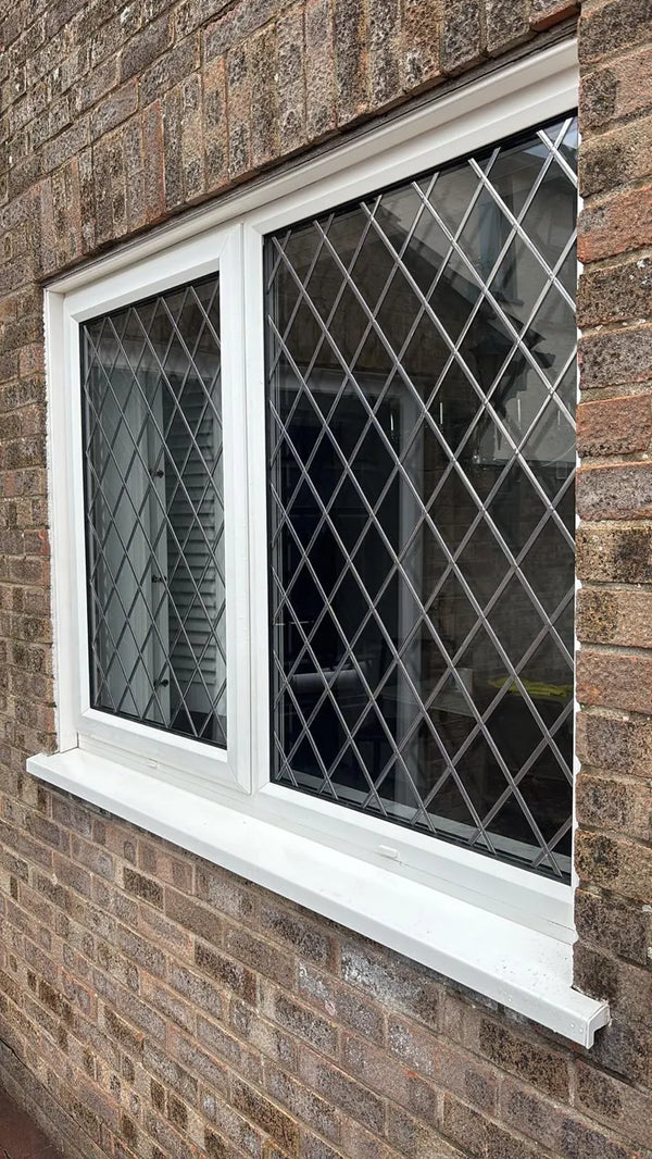 White uPVC window with Georgian bars and obscure privacy glass in a bathroom, Bristol