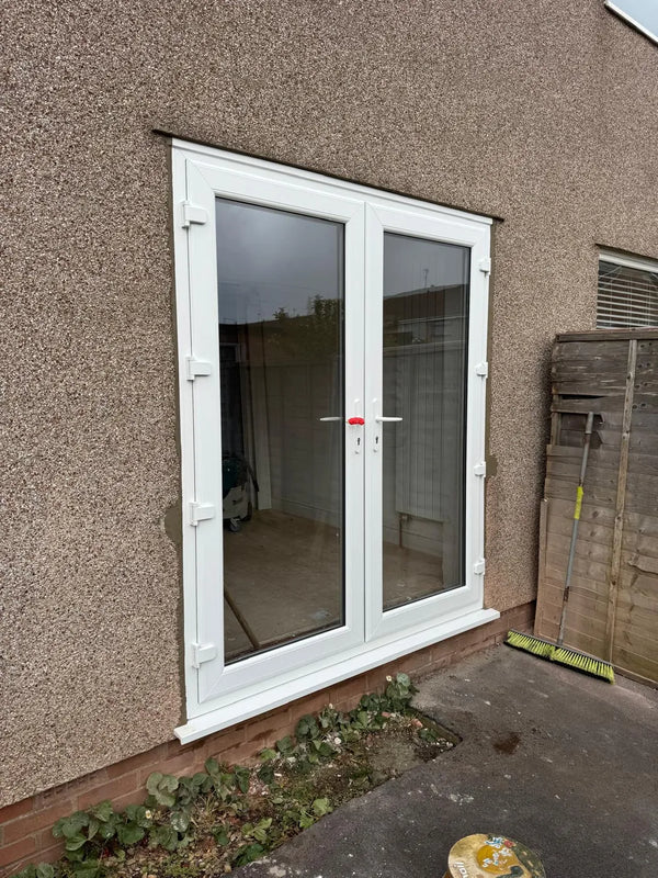 New white uPVC French doors installed on a rendered home exterior, Pane Relief Bristol