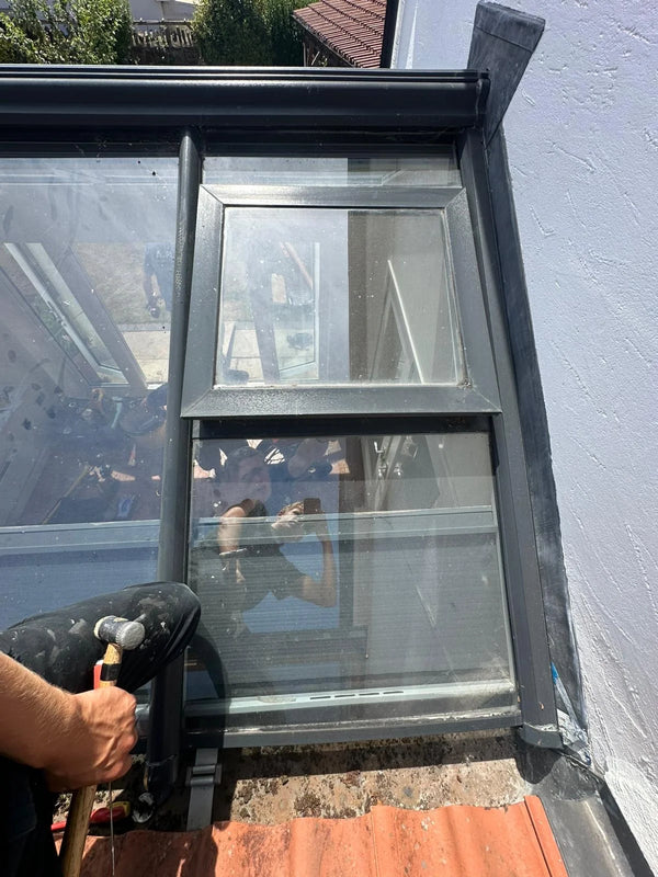 Window installer fitting new double glazed unit from exterior in Bristol